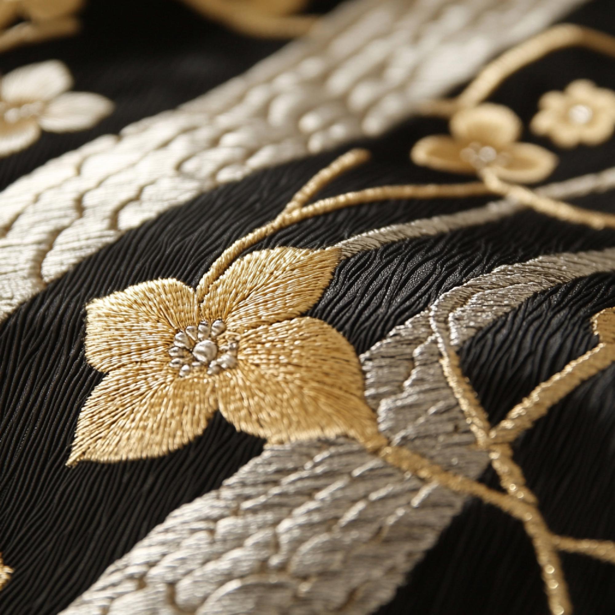 Close-up of gold thread embroidery on cotton